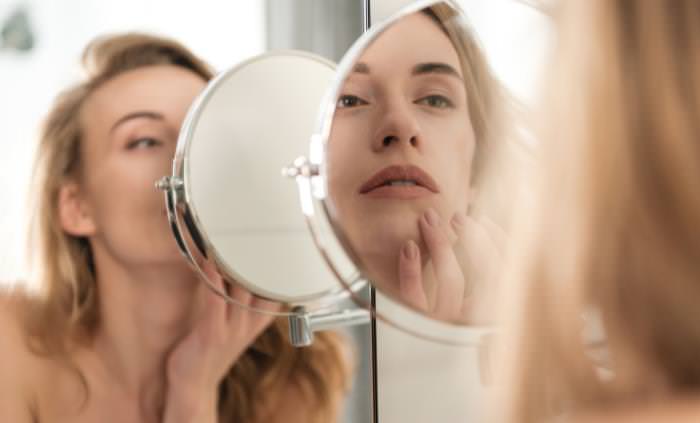 woman looking in the mirror