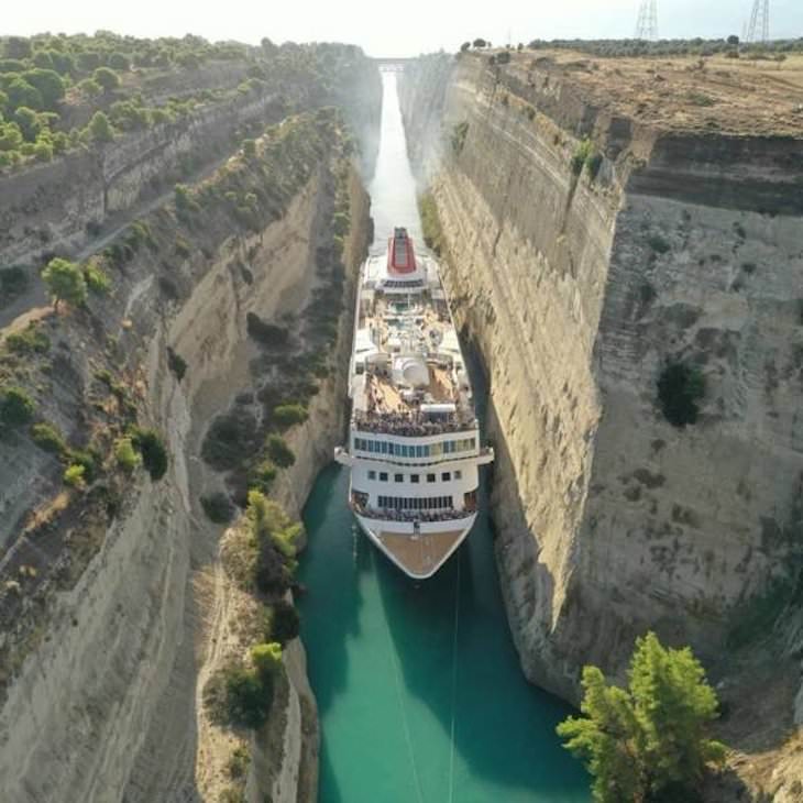 19 Images Showcasing the World’s Endless Wonders, A Huge cruise ship squeezing through the Corinth Canal, Greece