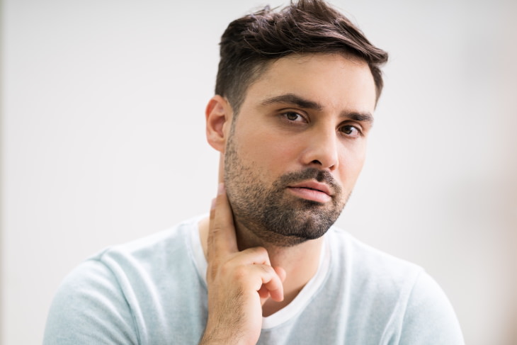 Iodine Deficiency man touching neck