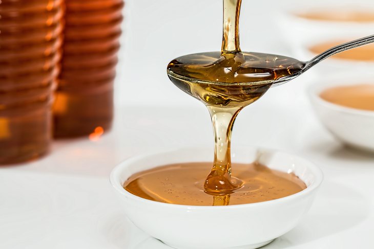 Honey vs Sugar Honey on a spoon