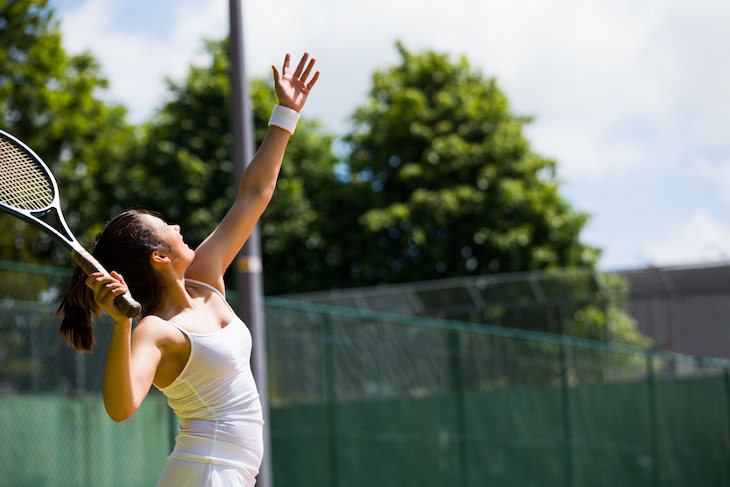 Common Causes for Pain Between Shoulder Blades, woman playing tennis