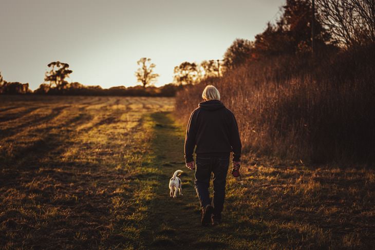 Stiff Neck man walking a dog