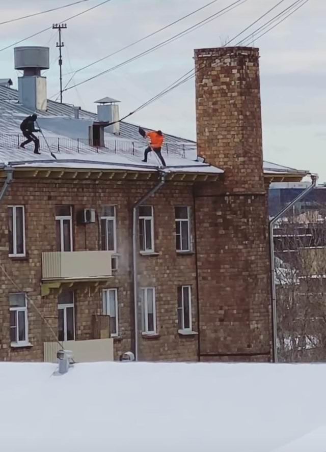 Work Safety Fails clear the snow from a roof