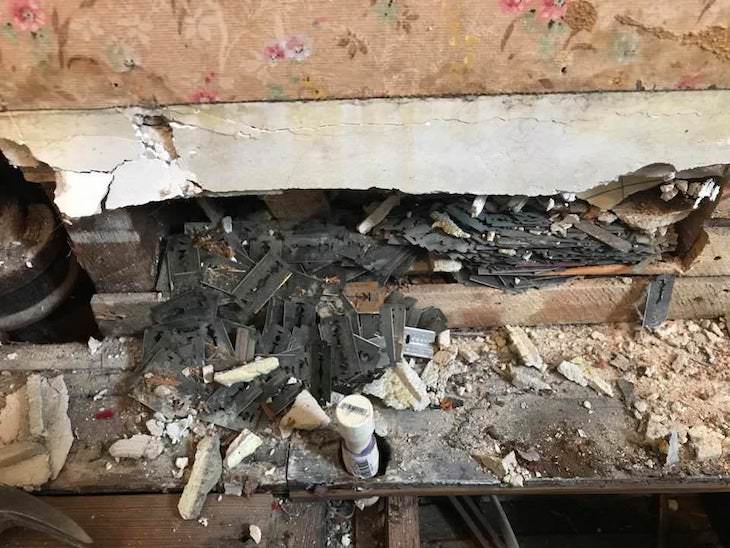 Why Old Homes Might Have Razor Blades In the Walls, blades pouring out of a wall during renovation