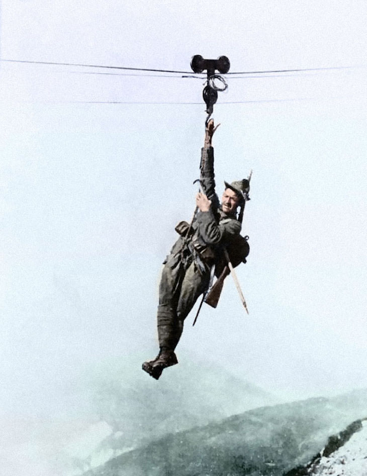 Rare and Beautifully Colorized Historical Photo An Italian Alpino mountain specialist ziplines from one peak to another, c. 1917