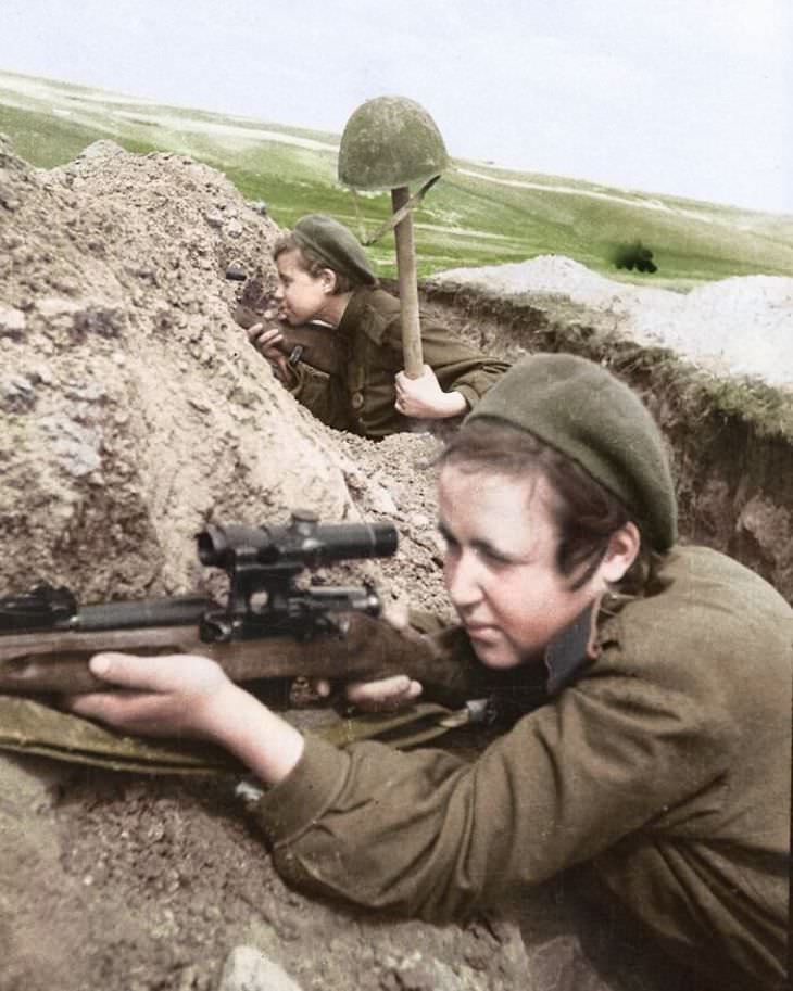 Rare and Beautifully Colorized Historical Photo Two female Russian snipers shooting from a trench somewhere in the Eastern Front, 1943