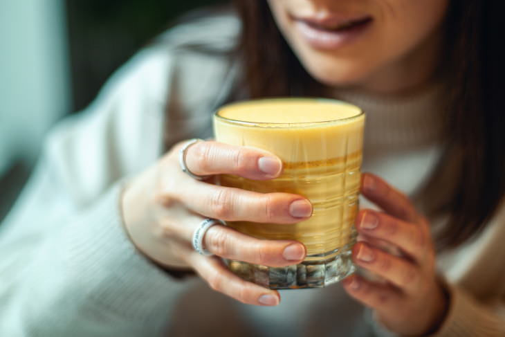 Turmeric Coffee woman drinking Golden Latte