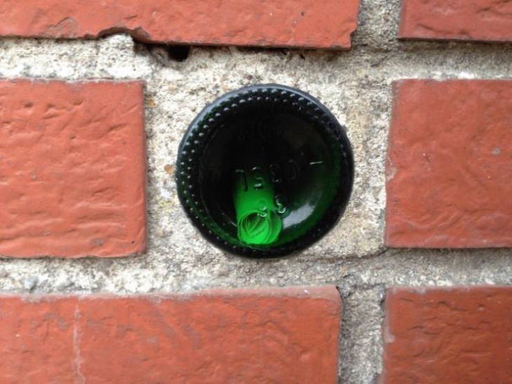 Confusing items a bottle with a small note inside in a wall