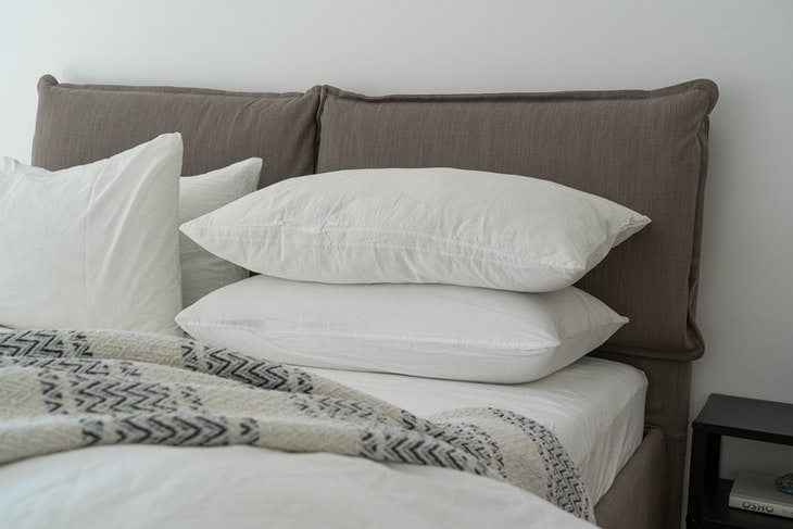 How to Get Better Sleep With a Stuffy Nose pillows stacked on bed