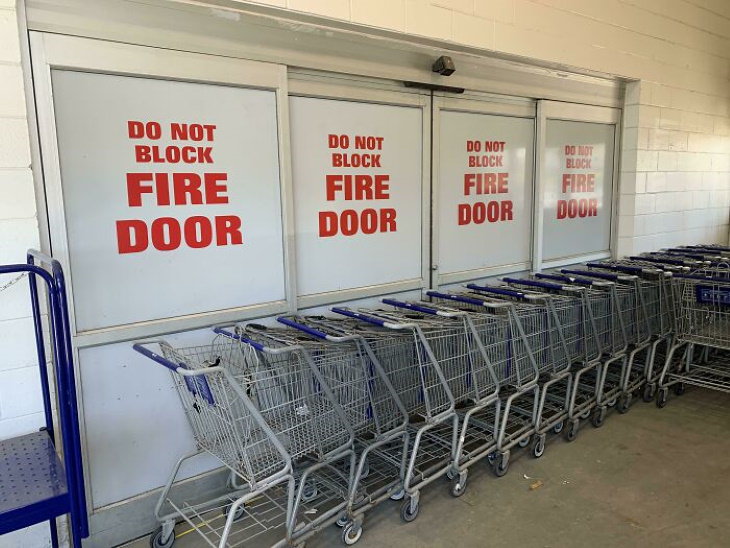 Construction Fails carts in front of fire door