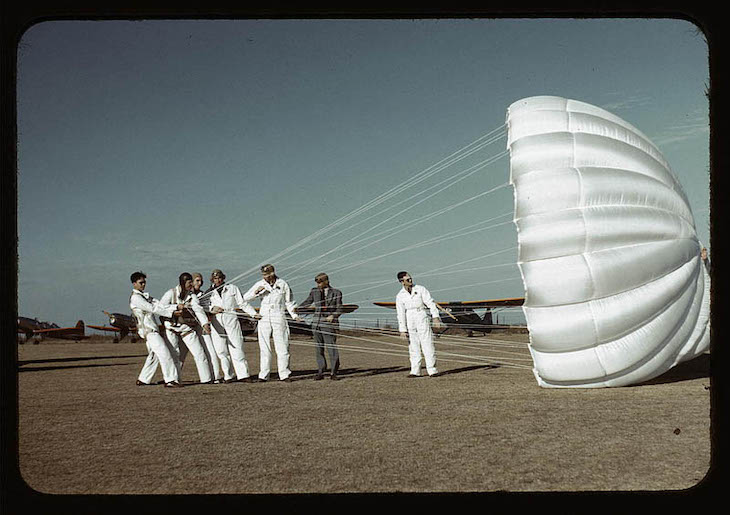 Historic Photos Depicting 1940s US in Vivid Color Instructor explaining the operation of a parachute to student pilots