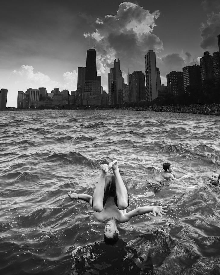 Evocative B&W Photography by Jason M. Peterson jumping in river