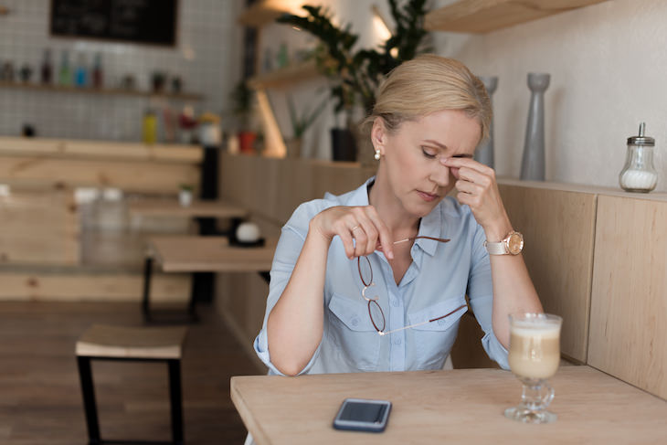 Surprising Signs of Dehydration To Watch Out For woman with headache