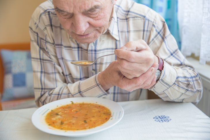 Stages of Parkinson’s Disease man with Parkinson's eating soup