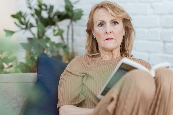 Stages of Parkinson’s Disease sad woman reading