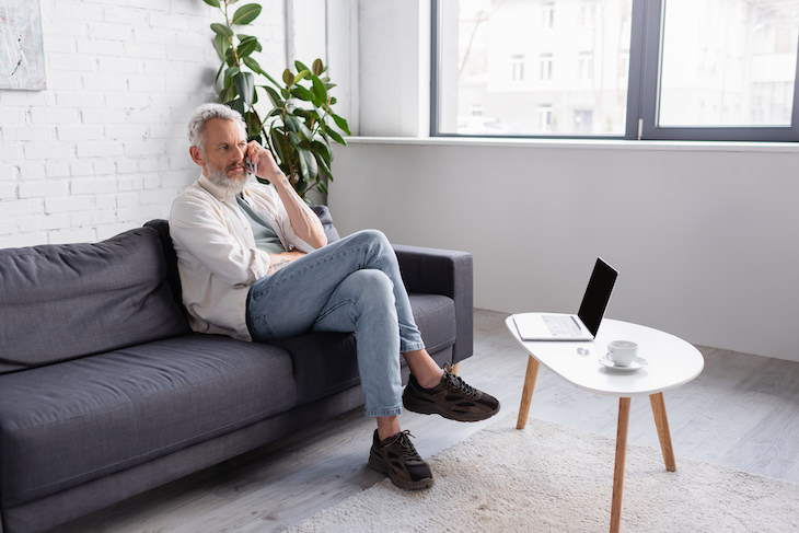 Why We Grunt When We Sit, Stand, Or Bend Over man sitting on couch