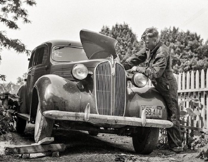 Man repairing his car, 1934