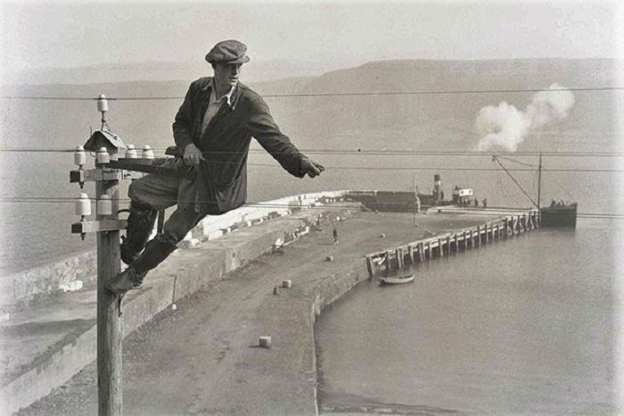 An engineer on a telegraph pole, 1936