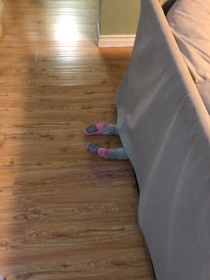 Kids Bad at Hide and Seek under the couch