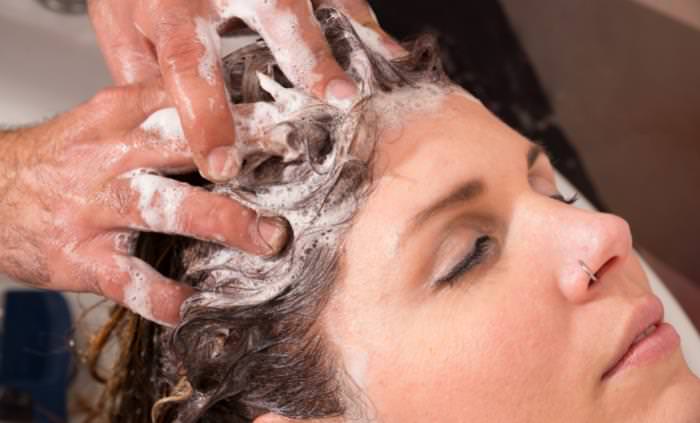 CBD woman having her hair shampood