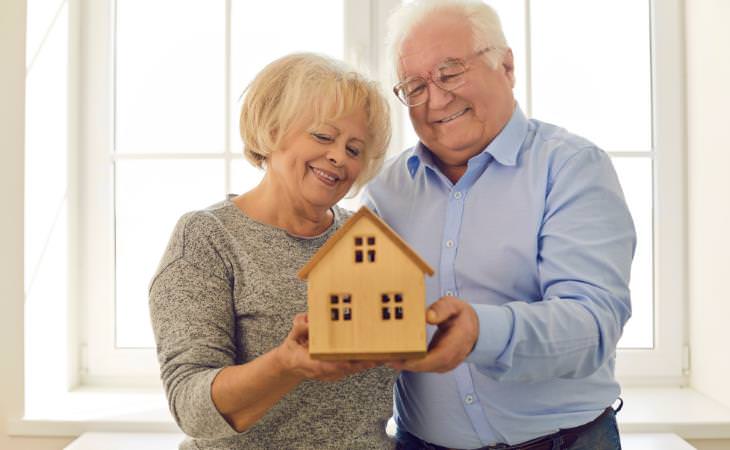 Grandparents holding a home model 