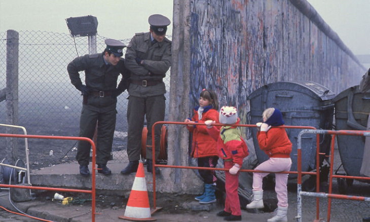Historical Photos West German schoolchildren talk with East German border guards near the Berlin Wall
