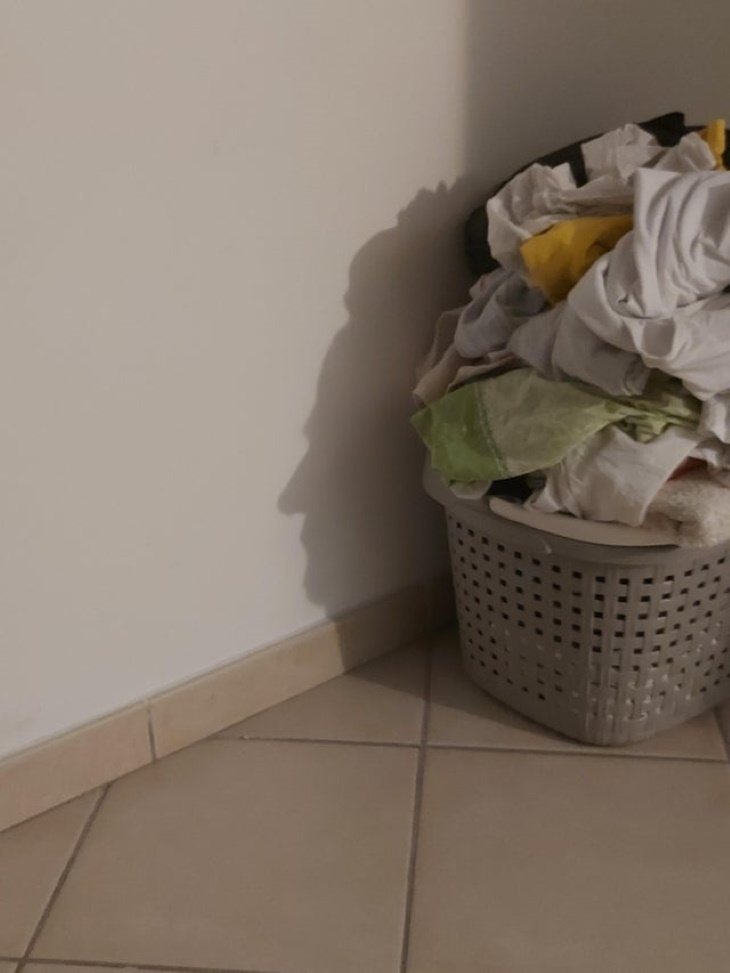 Confusing Pictures person's face laundry basket.