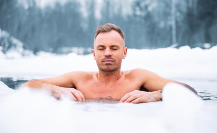 Build cold tolerance - man bathing in ice cold water