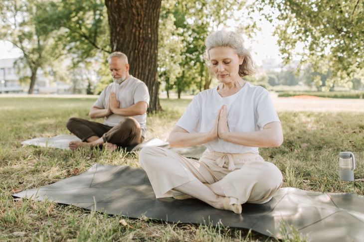 Yoga For Diabetes elderly man and woman practicing yoga outdoors