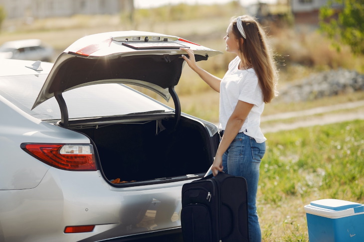 Car Organization Tips woman opening trunk