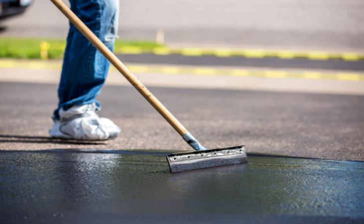 Sealing your driveway - squeegee spreading sealer 