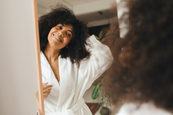 Faking a Smile woman smiling in the mirror