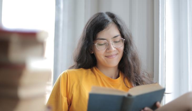 woman lovingly reading a book 