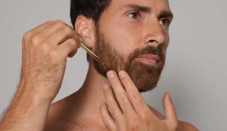 Beard Psoriasis - Man putting on beard oil