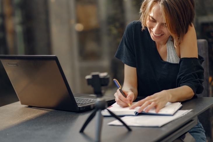 Outdated Email Phrases woman smiling and typing