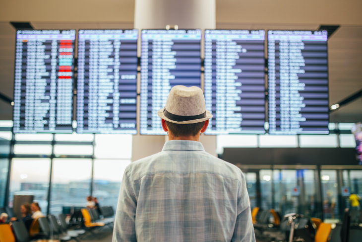  Flight Delay Tips man in hat at airport tableau