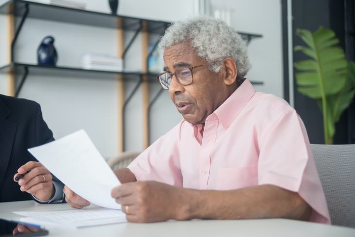 Will Mistakes elderly man reading a document