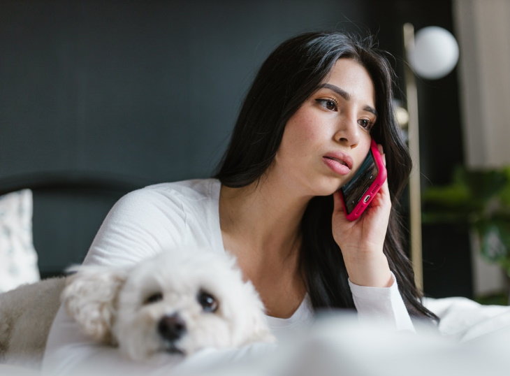 Heat Stress in Dogs woman with a dog talking on the phone