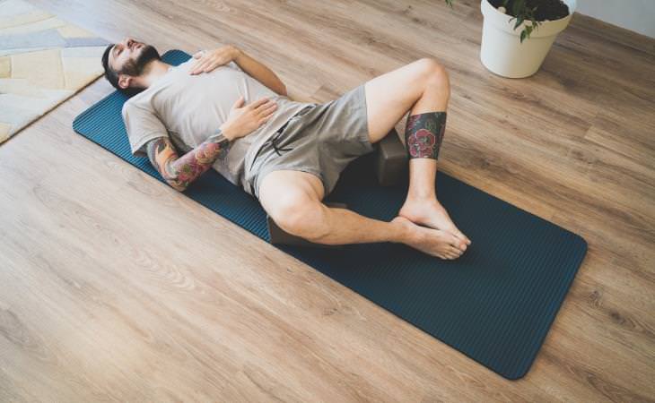 Diaphragmatic Breathing, man on a yoga mat breathing deeply
