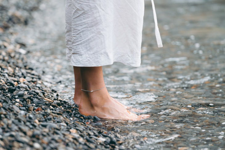 5-Step Summer Foot Care Guide woman standing barefoot in shallow water