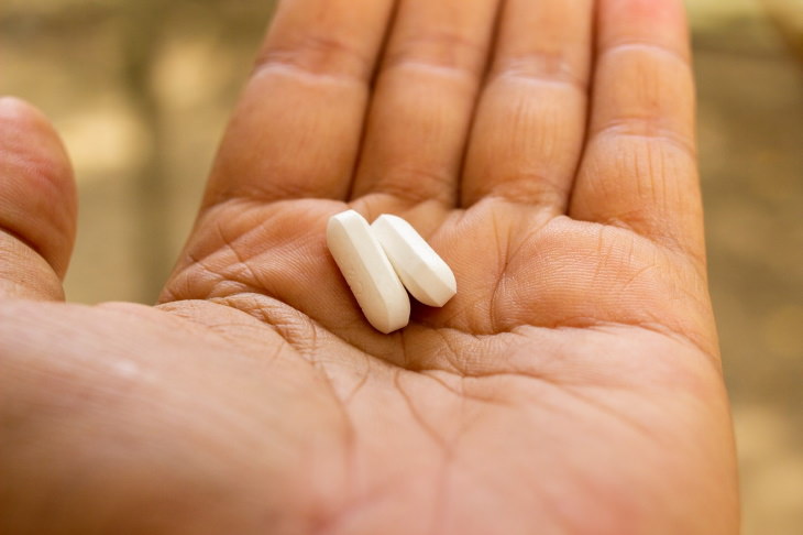 Lactose Intolerance Guide pills in hand