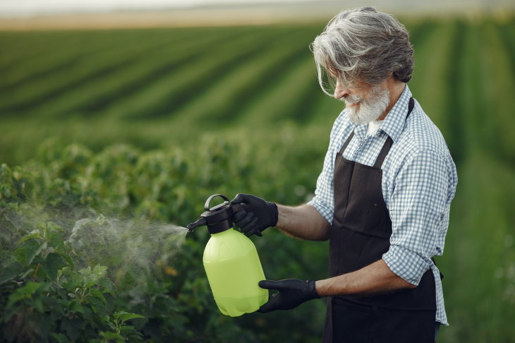 Plant Fertilizers farmer spraying plants