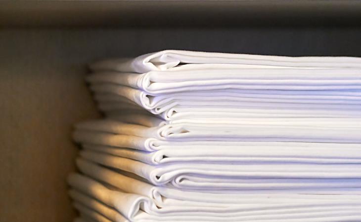 Laundry stripping - a stack of clean, folded white linens