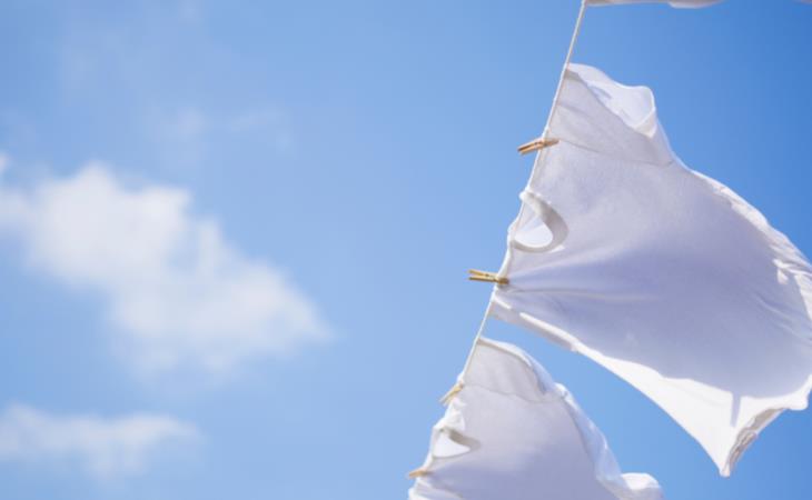 Laundry stripping - clean white Tshirts line drying in the sun