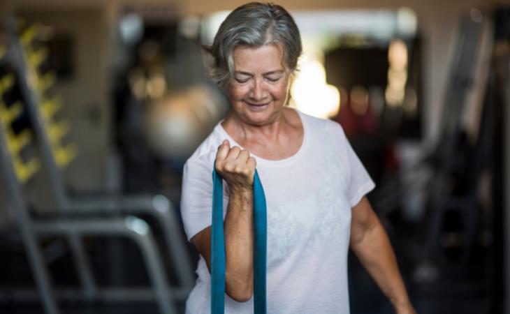 seniors exercise - woman stretching a resistance band 