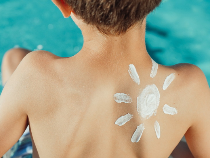 Types of Skin Cancer boy with sunscreen sun on back