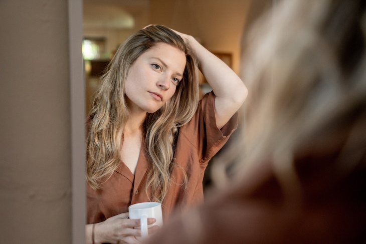 Puffy Face woman looking in the mirror morning