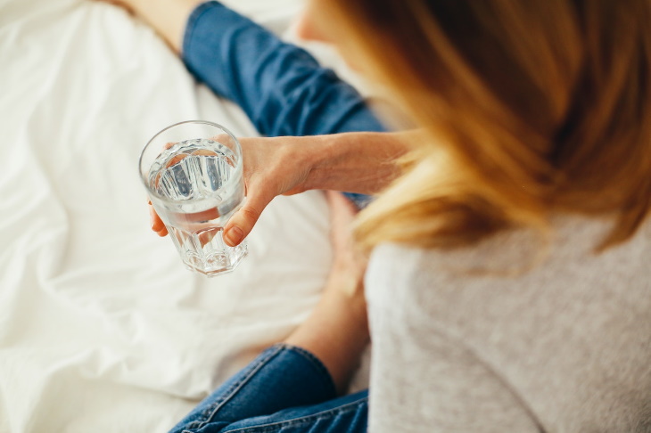 Puffy Face woman with a glass of water