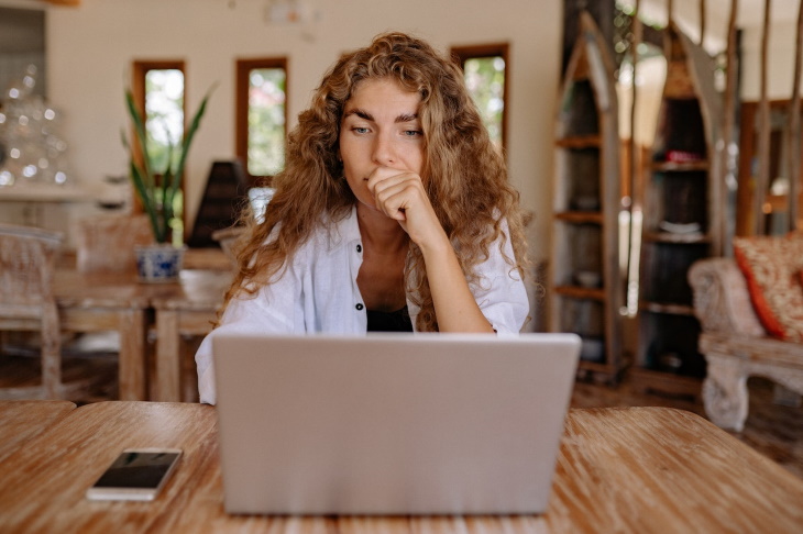 Passive-Aggressive Communication surprised woman in front of a laptop