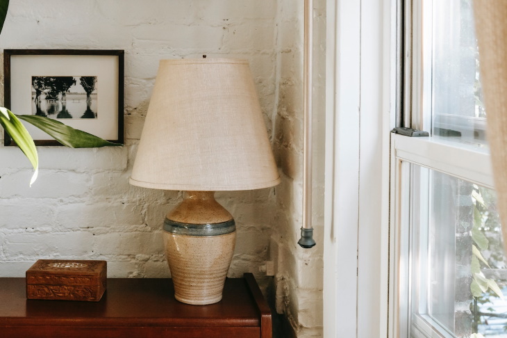 Timeless Interior Design Elements A table lamp with a barrel shade